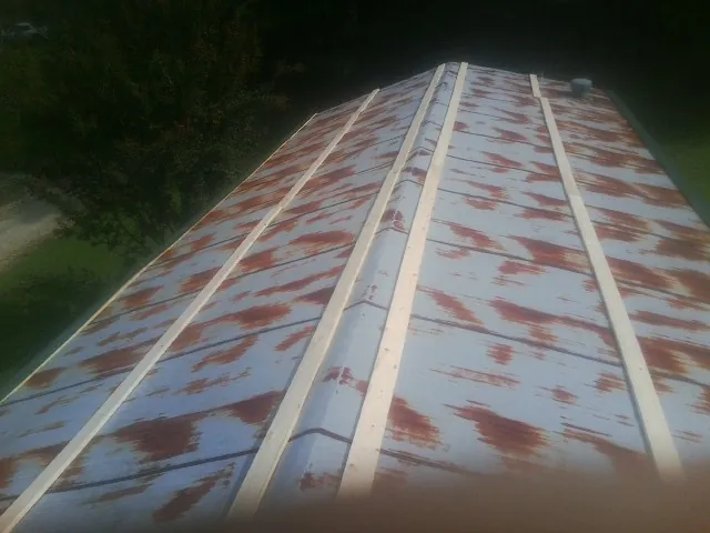 Rusted metal roof panels with new wood purlins before replacement — Storm Damage Roof Repair in Tougaloo by Roofing Brothers